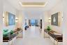Step through the grand double-door entry into a breathtaking gallery-inspired foyer, where perfectly balanced symmetry creates an immediate sense of e