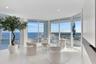 Positioned on the coveted southeast corner, this spectacular sitting room is wrapped in walls of glass, offering breathtaking panoramic views that str