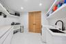 Even the laundry room has been designed on a grand scale. This exceptionally spacious laundry and garment-care suite combines beautiful design with ex