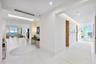 A dramatic split foyer welcomes you through carved-wooden double entry doors, where two gallery-style hallways gracefully divide the residence into it