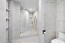 clean modern sculptured shower and towel shelving with LED lighting throughout