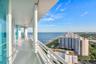 Expansive covered balconies, finished in elegant European porcelain, wrap the residence in spectacular southeast-facing views where the turquoise Atla