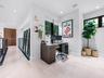 Light-toned large-format tile flooring, recessed ceiling lighting, metal cable railing system, and tall windows with dark trim