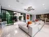 Open-concept interior featuring large-format polished tile flooring, recessed ceiling lighting, a contemporary multi-arm chandelier, and floor-to-ceil