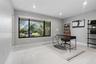 Large picture window with black frames, recessed lighting, and light-toned tile flooring