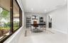 Expansive horizontal window with dark trim, large-format tile flooring, and recessed ceiling lighting