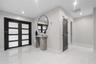 Foyer featuring double-entry doors with frosted glass panels, polished tile flooring, recessed lighting, and a louvered door