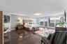 Wood-finish flooring, textured accent wall, and expansive glass sliding doors providing external access