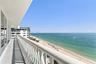 Private balcony featuring a white aluminum railing, concrete flooring, and direct oceanfront exposure
