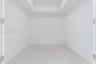 Interior space featuring a recessed ceiling, white walls, and large-format tile flooring