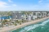Aerial perspective of coastal high-rise development featuring direct proximity to the Atlantic Ocean shoreline, sandy beaches, and expansive waterfron