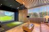 Recreation space featuring a projection screen, custom wood-slat ceiling and wall detailing, and light-tone wood parquet flooring
