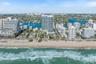 Aerial perspective of a coastal high-rise property featuring direct beach access, proximity to the Atlantic Ocean, and established waterfront surround