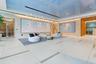 Lobby area featuring large-format tile flooring, a high-gloss reflective ceiling, recessed linear lighting, and integrated wall-mounted fixtures