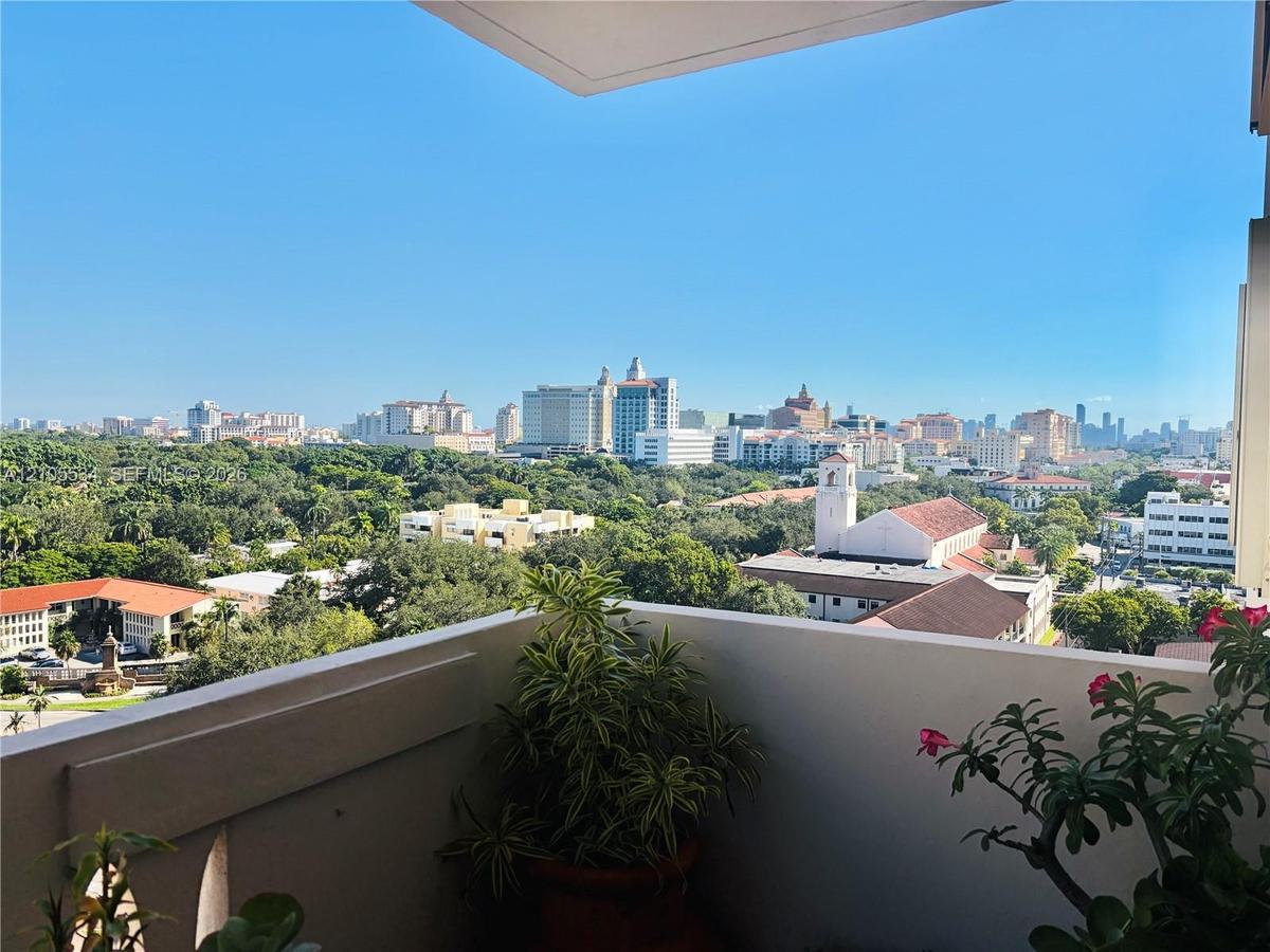 Private balcony featuring a masonry railing and panoramic city skyline backdrop