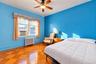 Parquet wood-finish flooring, ceiling fan with integrated lighting, and multi-pane window