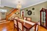 Parquet wood-finish flooring, crystal chandelier, decorative ceiling medallion, crown molding, and wooden staircase with turned balusters
