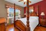 Parquet hardwood flooring, dual-tone wall finishes, and a ceiling-mounted fan with integrated lighting