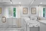 Bathroom featuring a glass-enclosed shower with brass hardware, vanity with stone countertop and integrated sink, recessed lighting, and stone-finish 