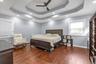 Tray ceiling with recessed lighting, multi-blade ceiling fan, and wood-finish flooring