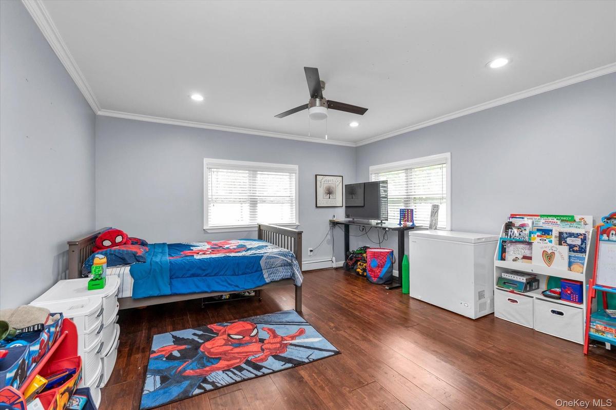 Interior space featuring wood-finish flooring, crown molding, recessed lighting, and a modern ceiling fan