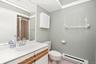 Second Bathroom has sink with vanity and stall shower