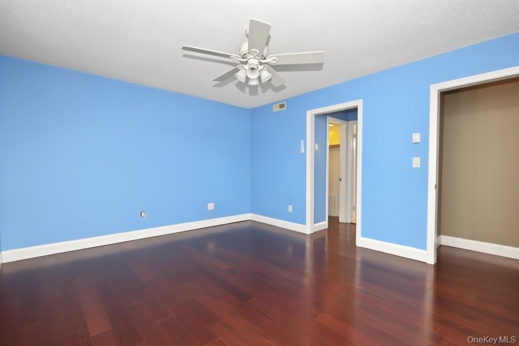 Primary Bedroom has ceiling fan with light