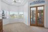 Large Sitting Area in the Primary Bedroom with Bay Window and French doors leading to the Lanai