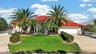 Palm-Lined Home With Circular Driveway