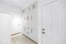 Custom cabinetry featuring ample storage solutions for laundry detergents, bulk household inventory, and utility organization.