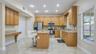 Spacious kitchen view from the dining room, featuring modern finishes and an open-concept layout.