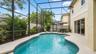 Spacious pool area viewed from the patio entrance.