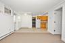 Interior space featuring wooden cabinetry, neutral wall-to-wall carpeting.