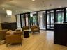 Lobby featuring stone tile flooring, wall-to-wall mirrors, recessed lighting, and black-framed glass entry doors
