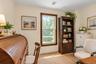 Room featuring neutral walls, wood-trimmed window, and wood-finish flooring