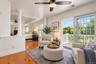 Virtually staged to showcase an inviting private sitting area within the primary suite, this beautifully designed space features elegant architectural