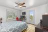 A nicely appointed bedroom offers a peaceful retreat, featuring a private balcony, adjoining bath, and spacious walk-in closet, creating an inviting s