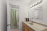 Thoughtfully designed to serve two upstairs bedrooms, this uniquely configured adjoining bath features separate entrances and individual vanities, off