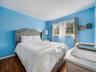 Room featuring wood-finish flooring and a multi-pane window with natural light