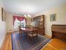 Formal dining area featuring wood-finish flooring and a multi-arm chandelier