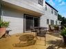 Rear wood deck featuring an attached wood railing and a sliding glass door