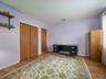 Hardwood flooring, wood-finish sliding closet doors, and wall-mounted shelving