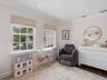 Neutral-toned room featuring crown molding, recessed lighting, grid-pattern windows, and dark-toned flooring