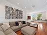 Living space featuring wood-finish flooring, recessed lighting, built-in cabinetry, and window seating