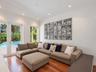 Interior space featuring wood-finish flooring, recessed lighting, crown molding, double glass-paneled doors, and floor-to-ceiling windows