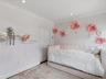 Room featuring crown molding, recessed lighting, and two wall-mounted floating shelves
