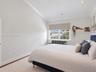 Vaulted ceilings featuring recessed lighting, crown molding, neutral carpeting, and a double-hung window with an integrated blind