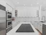 Kitchen featuring white cabinetry with glass-front display panels, quartz countertops, a central island with an integrated cooktop, double wall ovens,