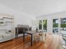 Wood-finish flooring, recessed lighting, crown molding, and dual glass-panel doors
