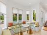 Bay window featuring built-in bench seating, recessed lighting, crown molding, and large-format tile flooring